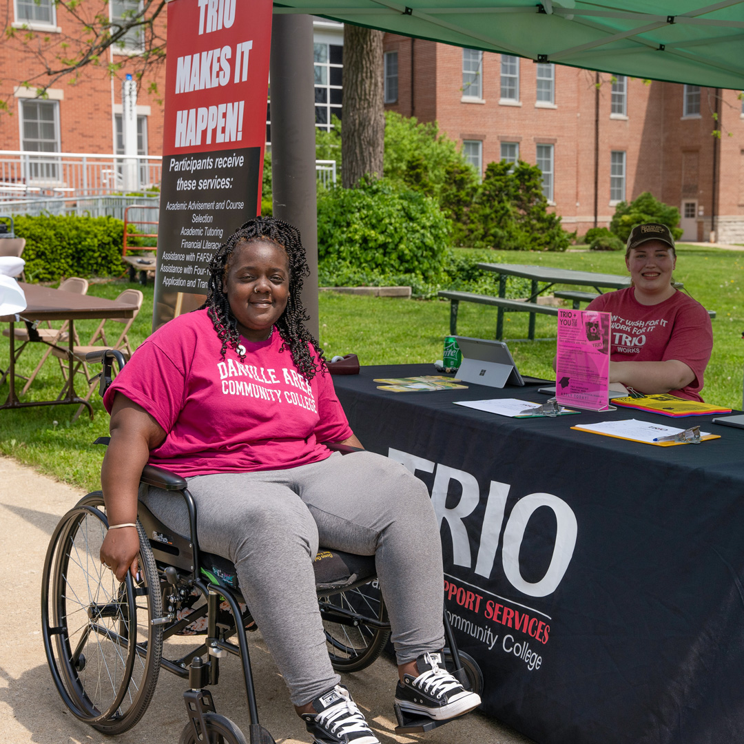 woman in wheelchair at trio booth