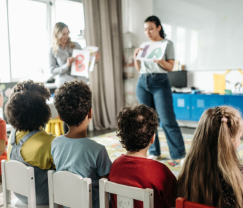 pre-school teachers teaching in front of students